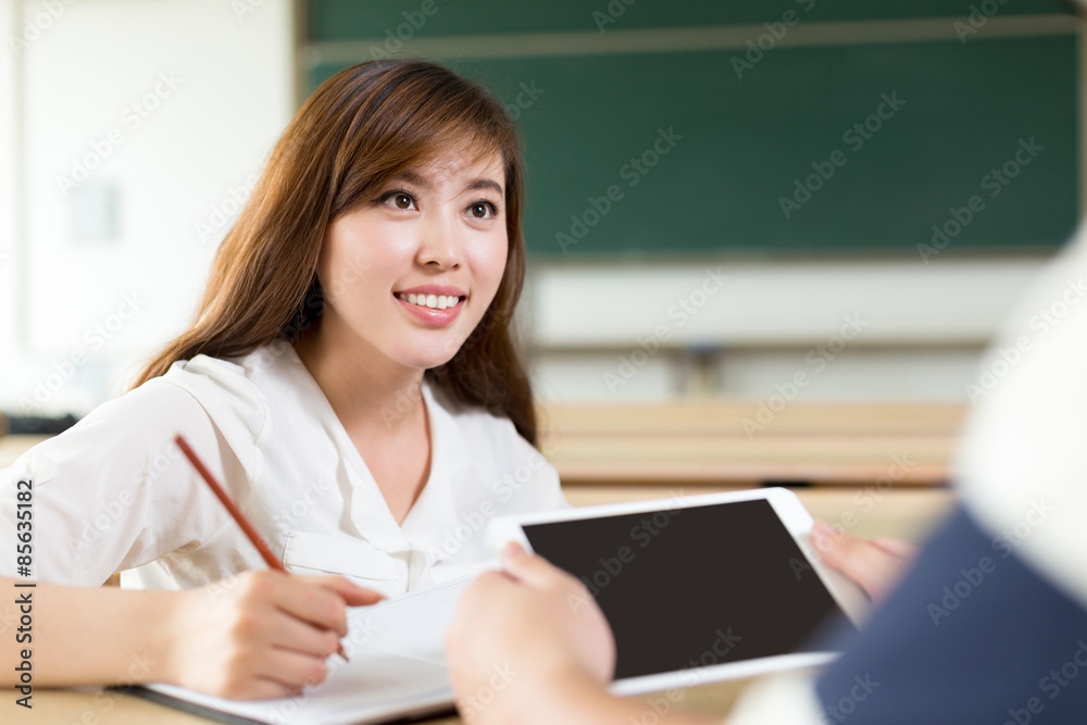 Two asian student discuss content on tablet when study in classr Two asian student discuss content on tablet when study in classr