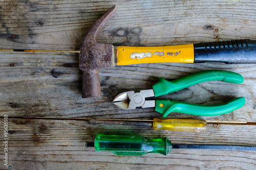 old many kinds of tools is placed on a wooden table