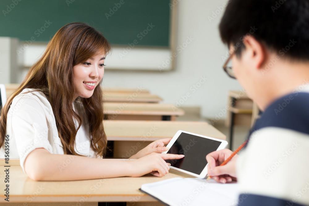 Two asian student discuss content on tablet when study in classr Two asian student discuss content on tablet when study in classr