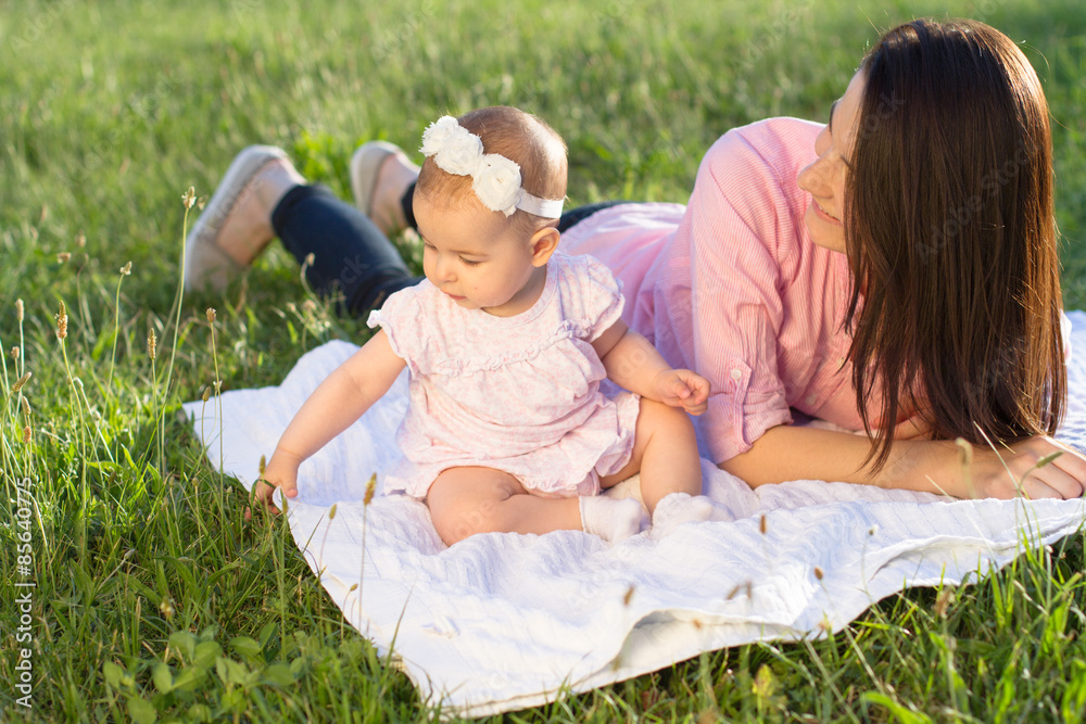 Fototapeta premium Happy mom and daughter playing at nature