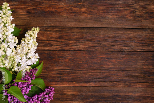 The beautiful lilac on a wooden background