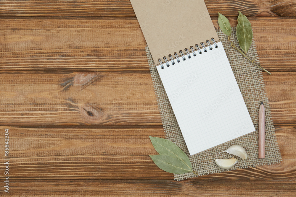 Blank notepad for copy space and herbs on wooden table Blank notepad for copy space and herbs on wooden table