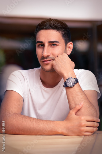 Young Man Sitting in a Restaurant