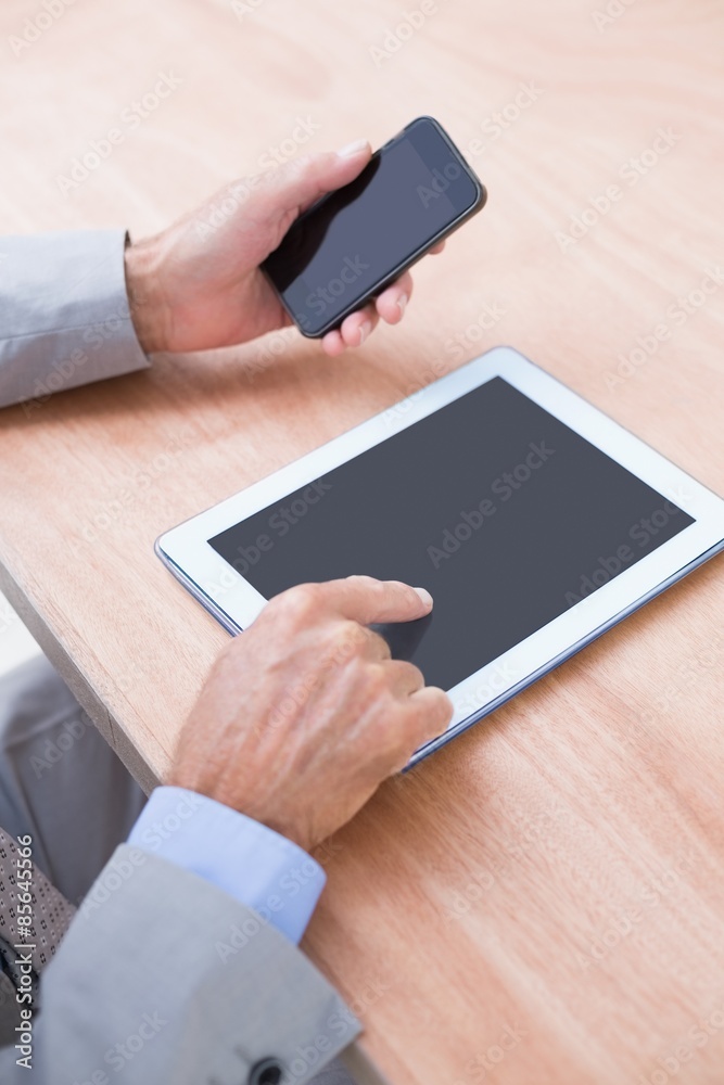 Businessman holding tablet and smartphone