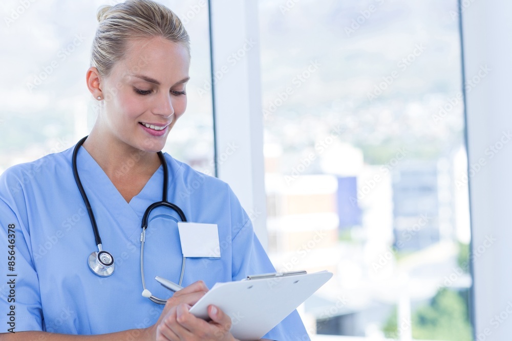 Happy doctor writing on clipboard Happy doctor writing on clipboard