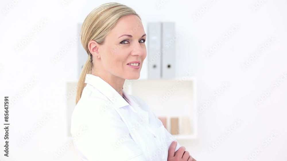 Smiling doctor looking at camera with arms crossed Smiling doctor looking at camera with arms crossed