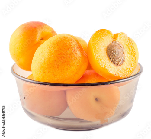 Yellow apricots in a transparent bowl