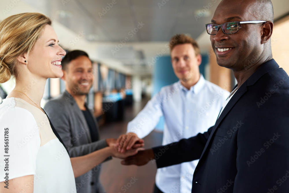 Group of young executives smiling before teamwork Group of young executives smiling before teamwork