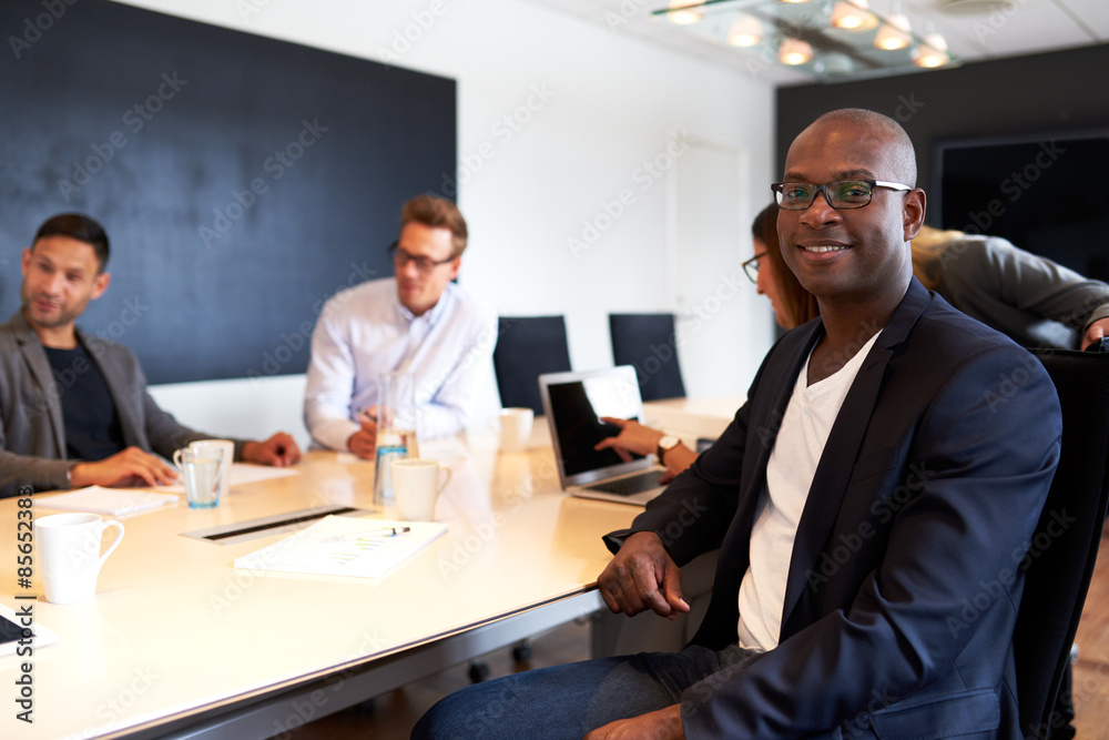 Black male executive facing camera during meeting Black male executive facing camera during meeting