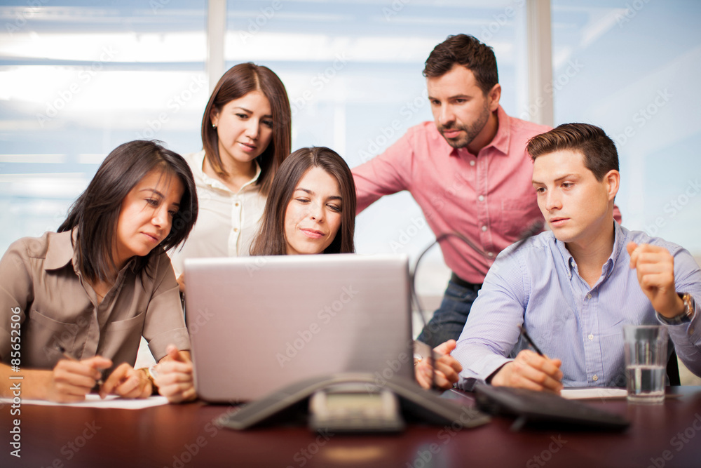 People looking at a laptop