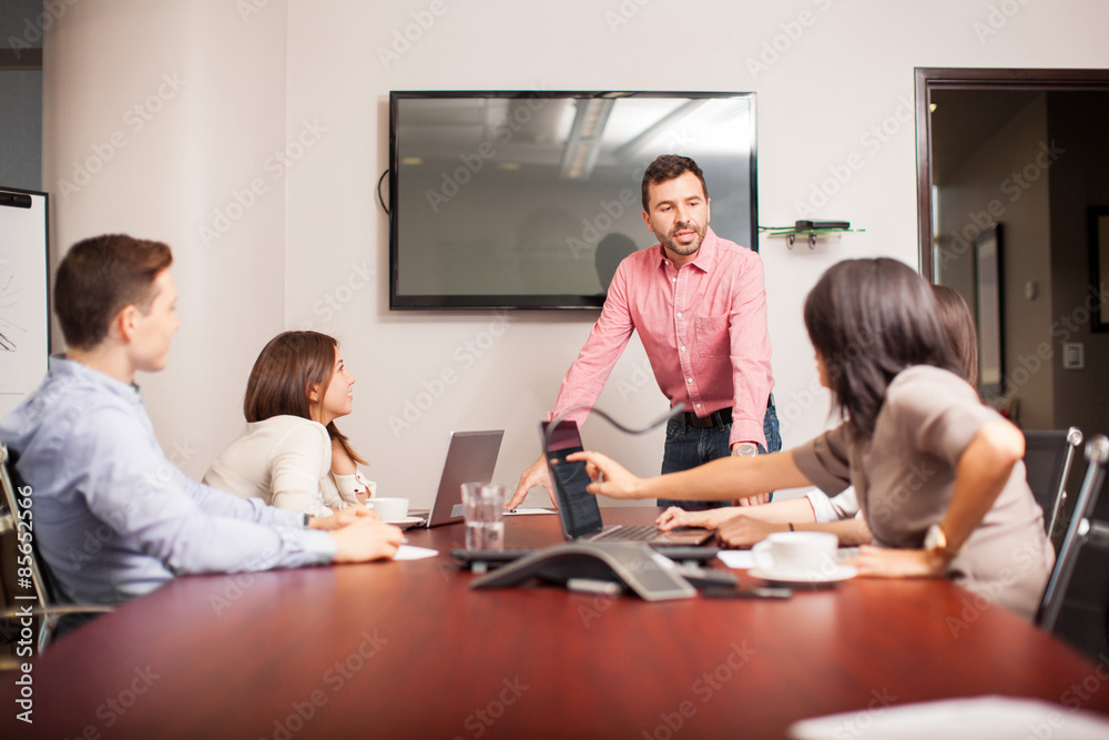 Fototapeta premium Young boss talking to his team