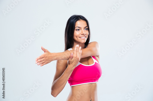 Smiling sports woman stretching hands © Drobot Dean