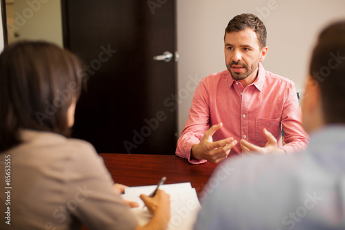Young Hispanic man talking during a job interview