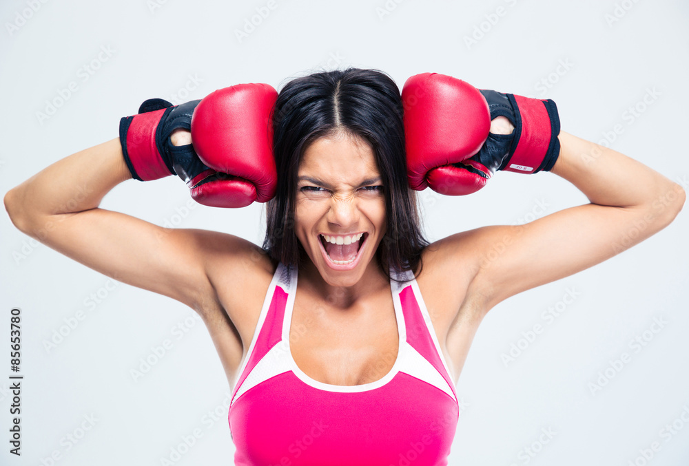 Fitness woman with boxing gloves screaming Fitness woman with boxing gloves screaming