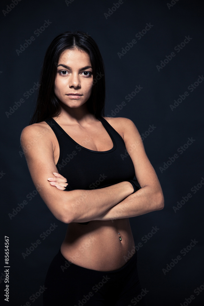 Sports young woman standing with arms folded Sports young woman standing with arms folded