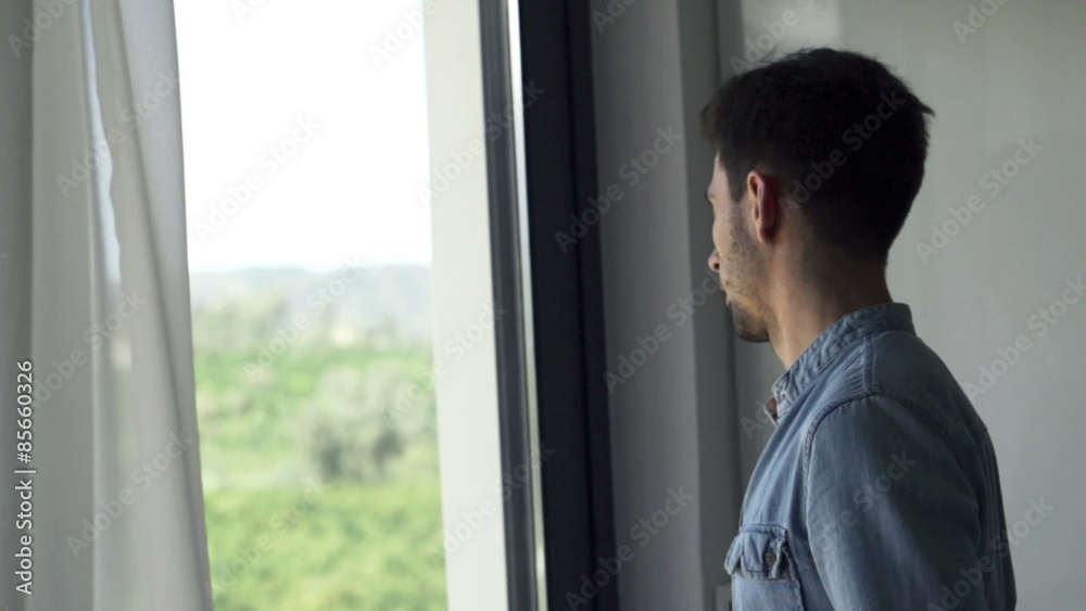 Man unveil curtain, opening door and stretching his arms
Man unveil curtain, opening door and stretching his arms