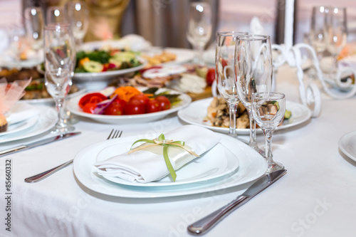napkin on a plate on the holiday table served with various dishe
