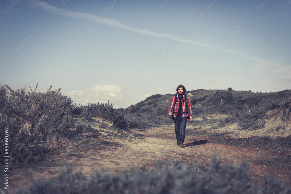 Young man hiking alone in the wilderness