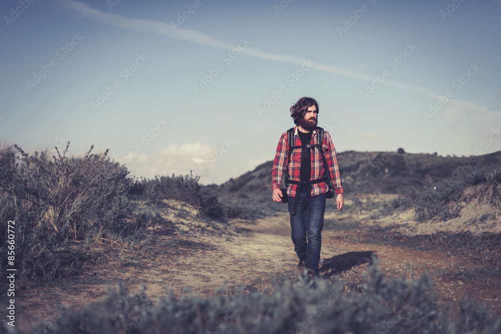 Young man hiking alone in the wilderness