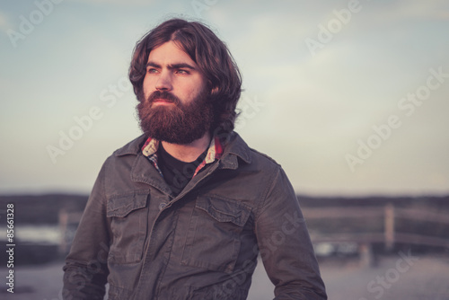 Tableau sur toile Handsome bearded young man standing staring