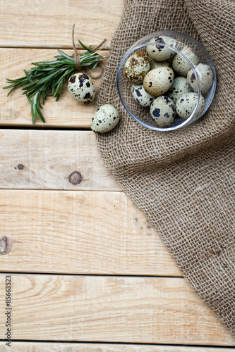Quail eggs, a bunch of rosemary and burlap 