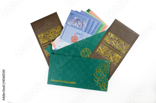 'Duit Raya' is money given from adult to children during Eid al-Fitr celebration in Malaysia. This is a Malay tradition and regarded as alms to the children.