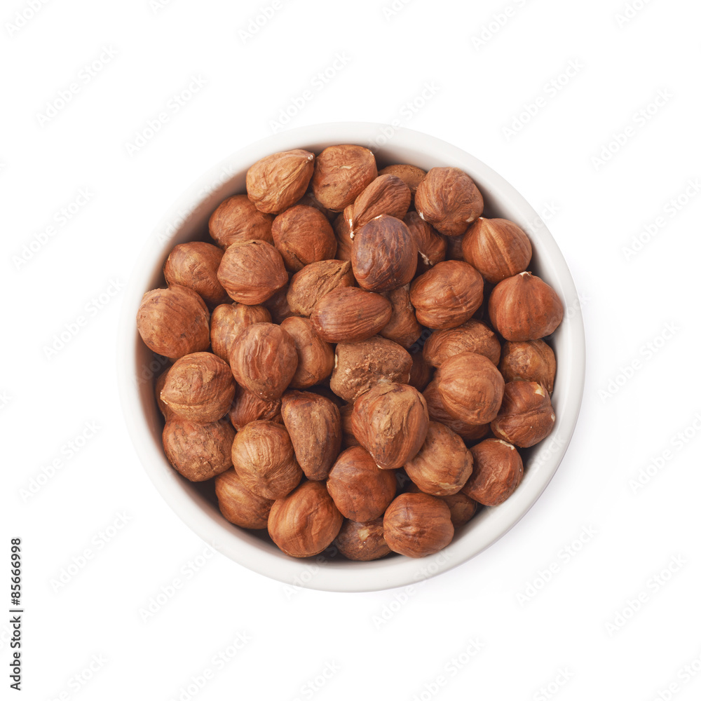 Cup filled with the hazelnuts isolated Cup filled with the hazelnuts isolated