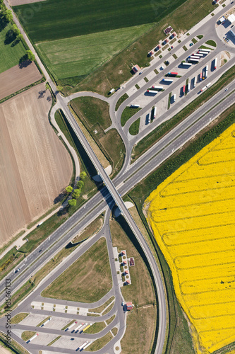 aerial view of highway and green, yellow harvest fields