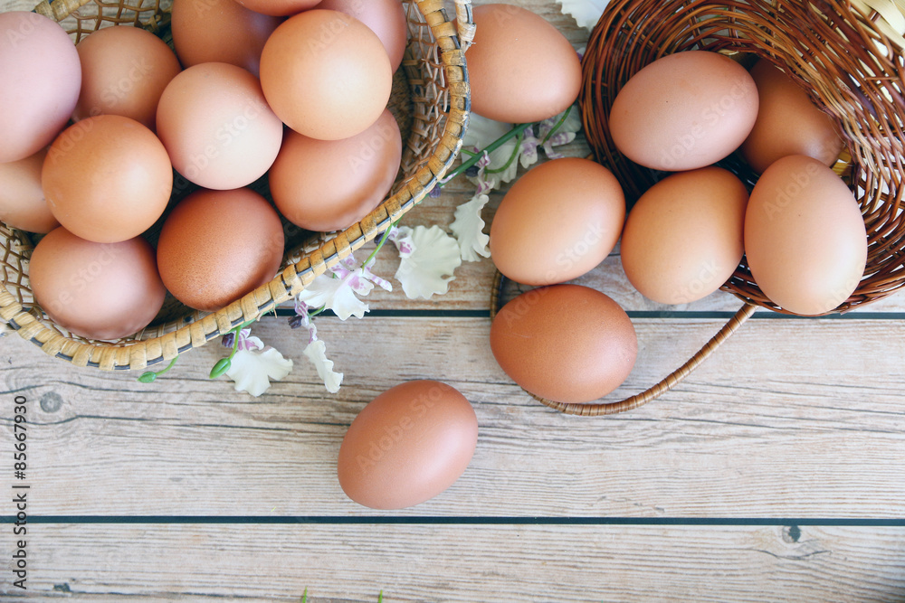 Eggs in the basket on wooden background Eggs in the basket on wooden background