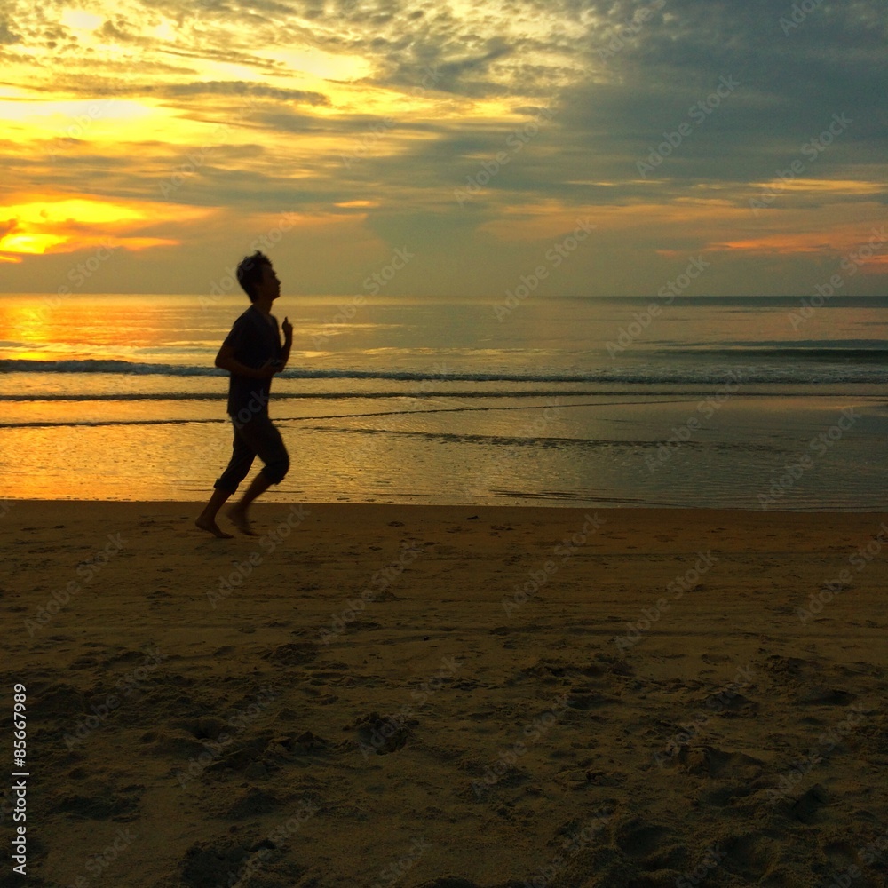 silhouette people running at the beach during sunrise