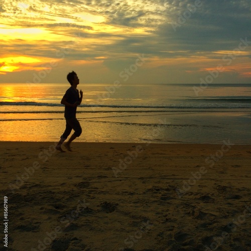 silhouette people running at the beach during sunrise