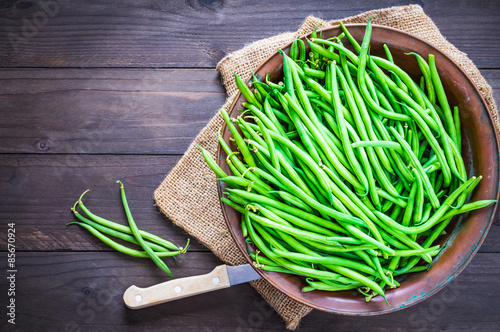 Green beans or fine beans on rustic wood.
