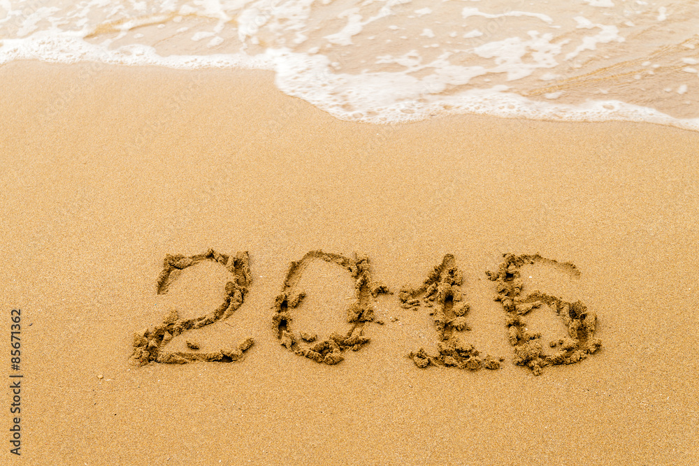 Fototapeta premium 2016 Yearwritten on sand, tropical beach. Selective focus.