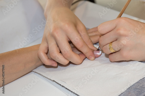Process of a manicure for woman at beauty salon