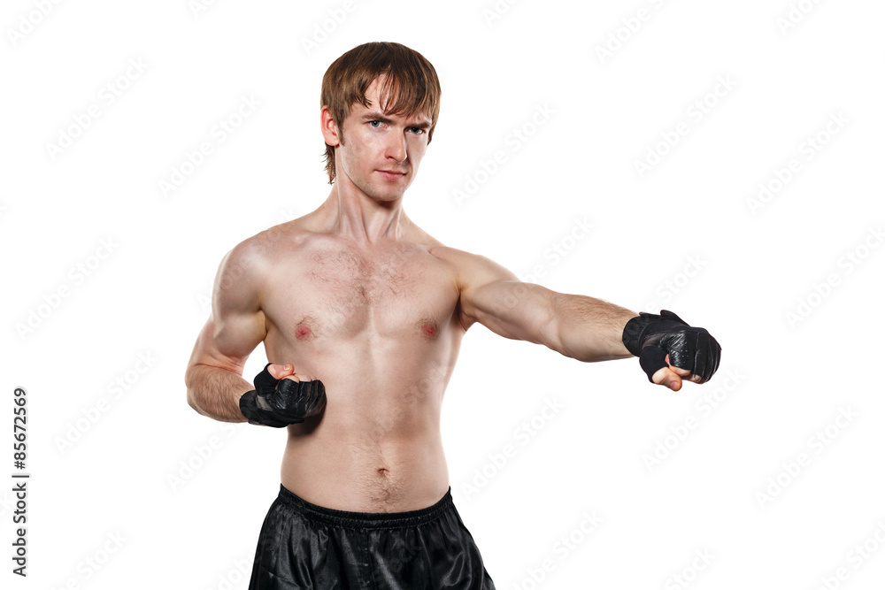 Fighter in mixed martial fighting gloves kick