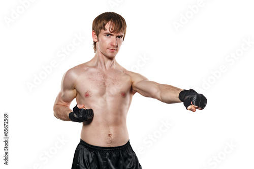 Fighter in mixed martial fighting gloves kick