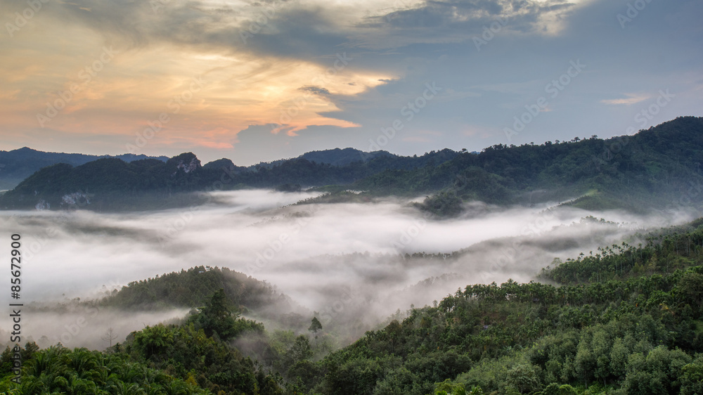Layer of mountains in the mist at sunrise time, Baan Nai Wong, Ranong Province, Thailand Layer of mountains in the mist at sunrise time, Baan Nai Wong, Ranong Province, Thailand