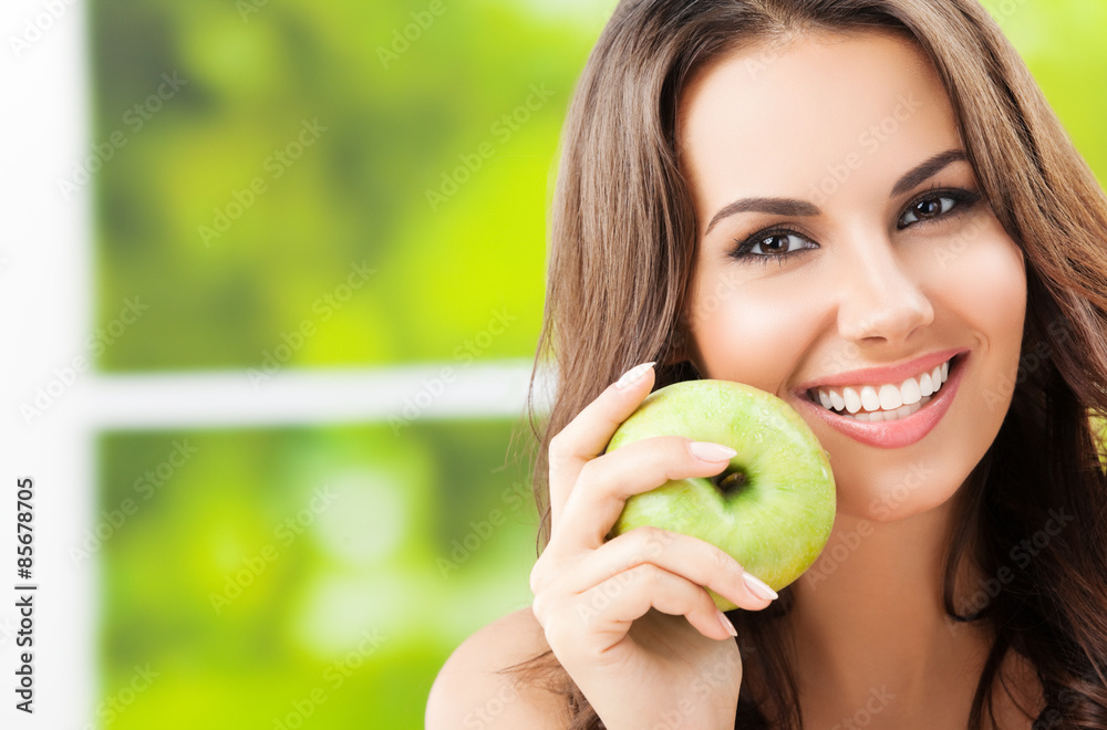 Young lovely woman with green apple, outdoors Young lovely woman with green apple, outdoors