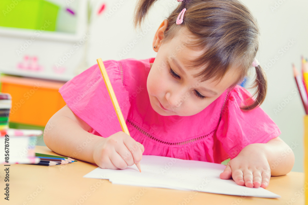Cute little girl drawing with colorful pencils Cute little girl drawing with colorful pencils
