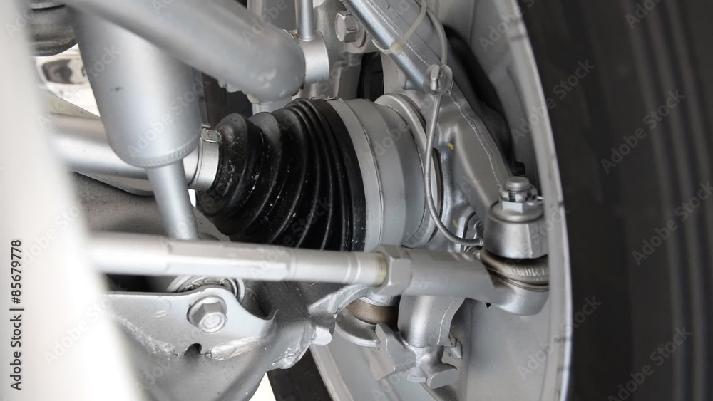 Rotation tire in motion with close up. car axis. Car engine closeup, Part of car engine