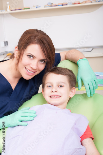 Friendly female dentist with boy patient