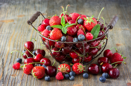 Fresh ripe berries, cherries, raspberries, blueberries in vintag