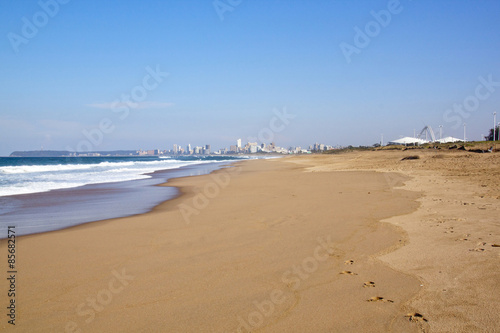 Empty Durban Beach at Low Tide Against City Skyline © lcswart