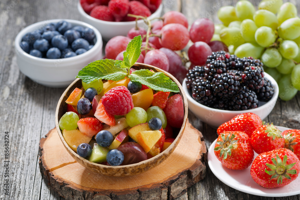 fruit salad in a bamboo bowl and fresh berries fruit salad in a bamboo bowl and fresh berries