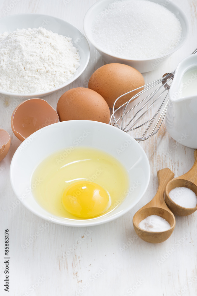 ingredients for baking on a white wooden table, vertical ingredients for baking on a white wooden table, vertical