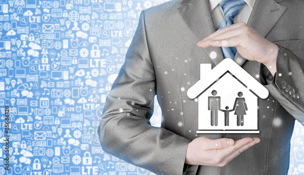 businessman protecting family in home with hands businessman protecting family in home with hands