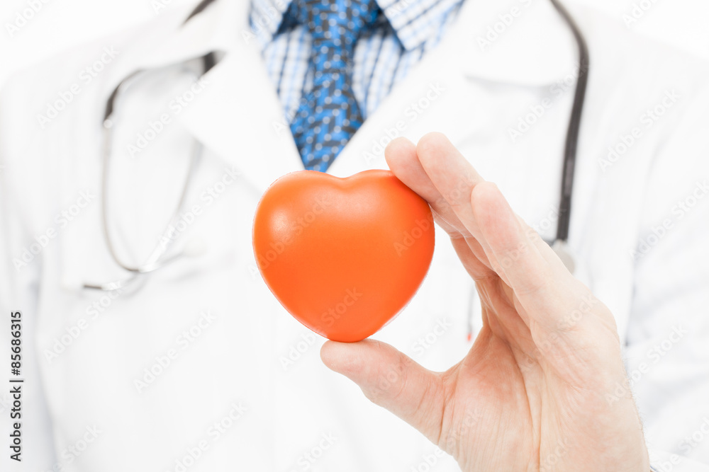 Doctor holding toy heart - health care concept Doctor holding toy heart - health care concept