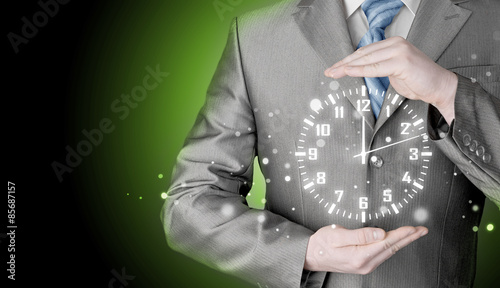 Image of businessman holding clock against illustration