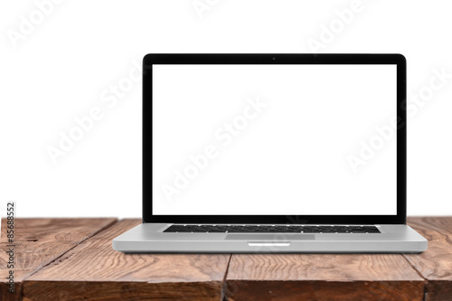 Laptop with blank screen on wooden table isolated