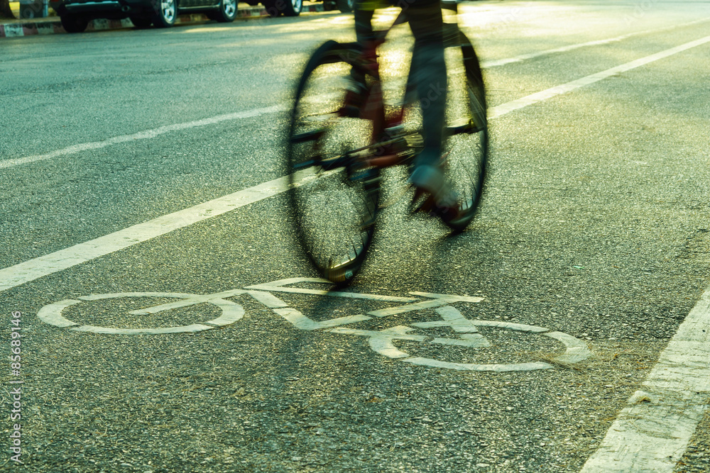 Fototapeta premium Motion blurred silhouette a part of cyclist going fast on a bike